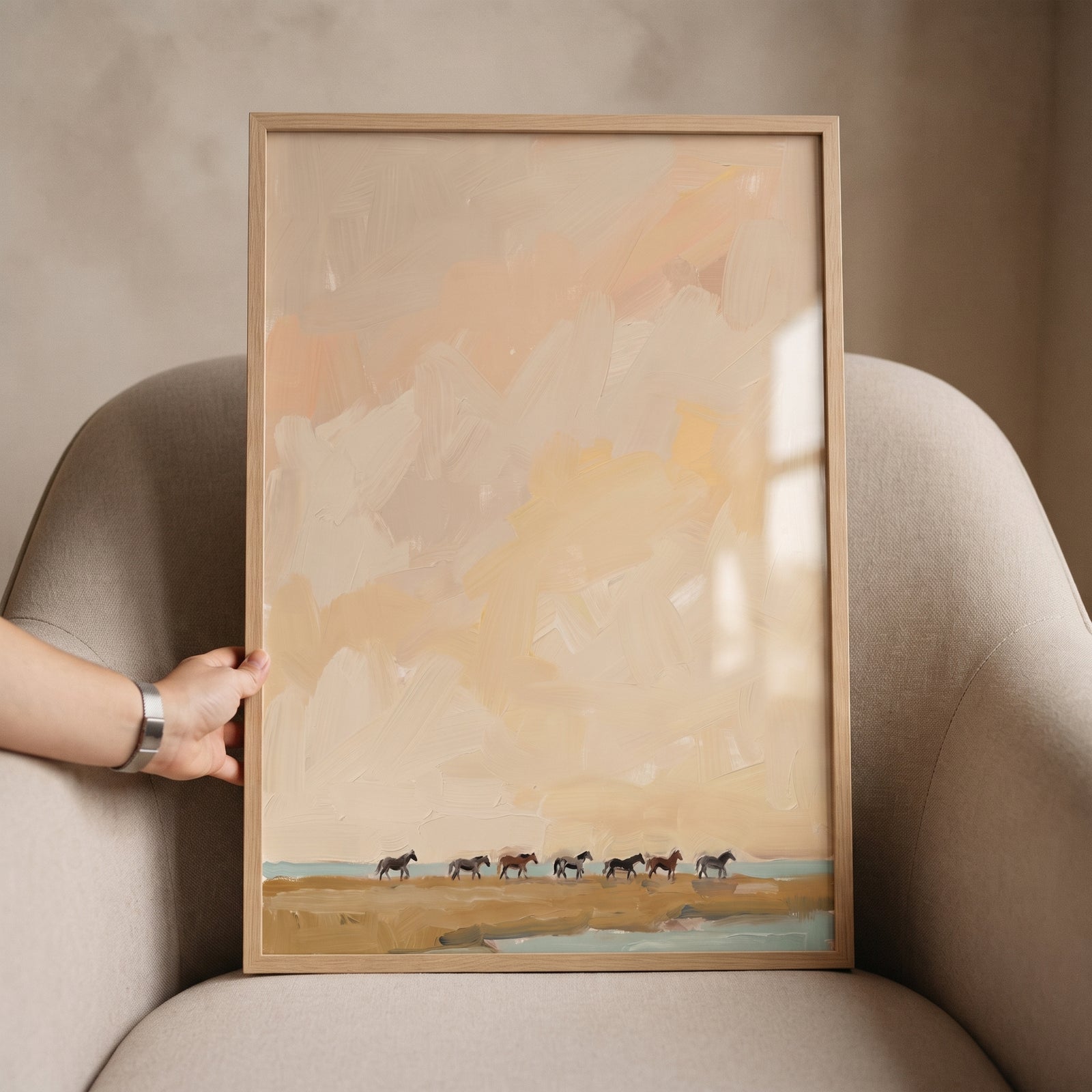 Minimalist beige roaming horses wall art in a wood frame featuring a row of horses against a textured landscape.