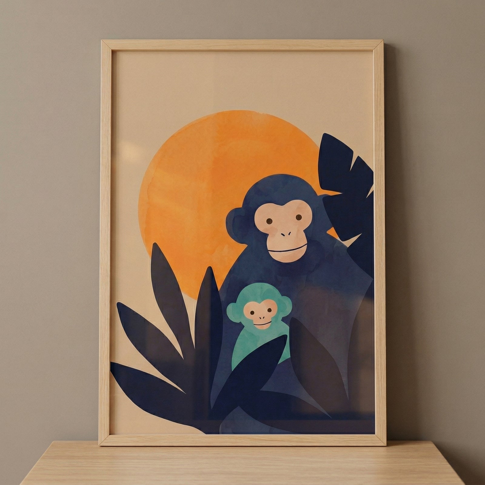 Framed illustration of a dark blue monkey holding a small baby monkey while peeking through large leafy shapes with an orange sun behind them. The artwork sits on a wooden surface and adds a calm and playful jungle theme to a nursery space.