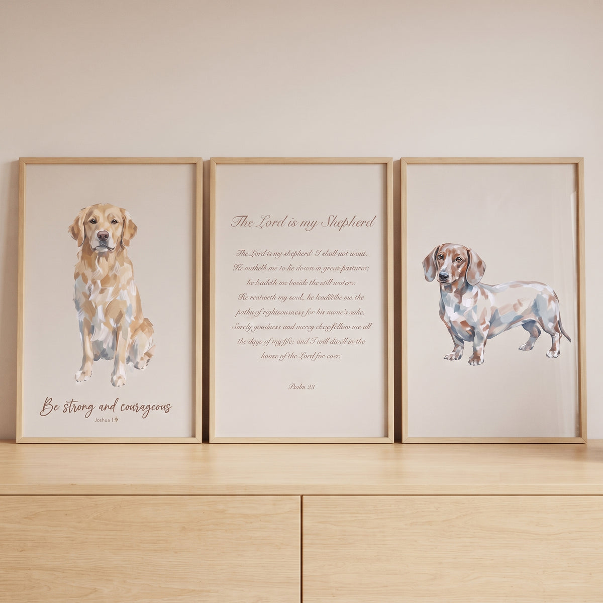Minimalist tan bible dog print set of 3 with watercolor dog portraits and scripture text on a light wood dresser.