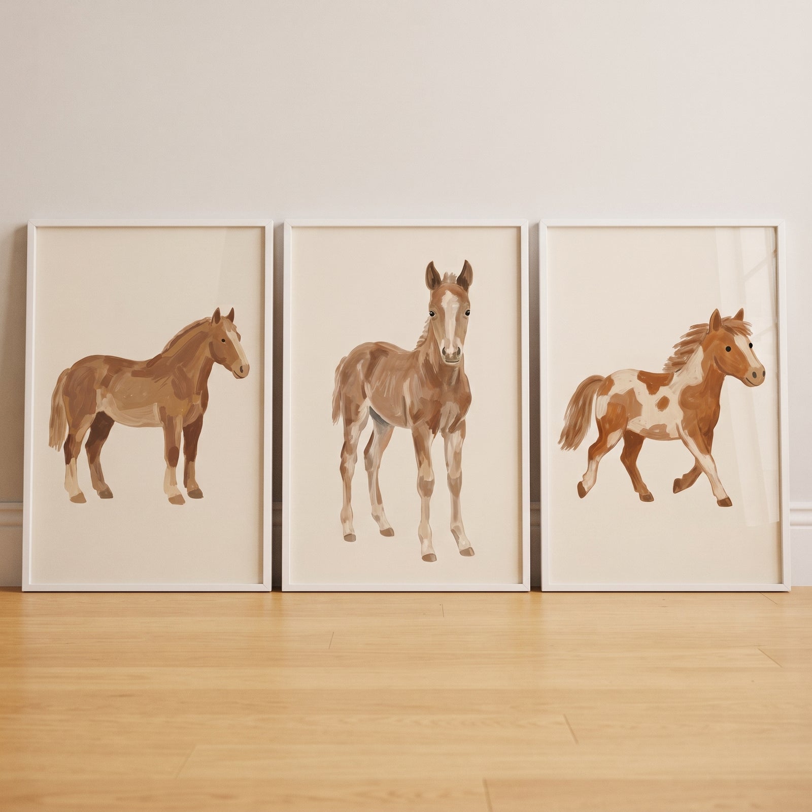 Minimalist tan horse artwork set of 3 features a brown horse, a foal, and a spotted pony in white frames.