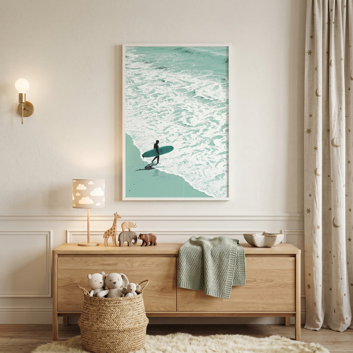 Minimalist teal ocean surfer wall art above a wood sideboard with wooden animal toys and a plushie basket in a nursery.