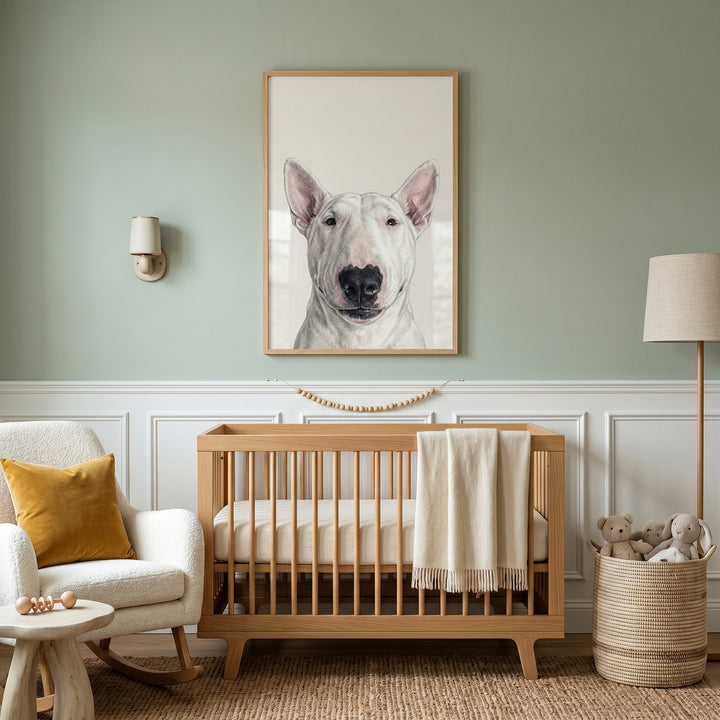 Minimalist white bull terrier wall art above a wooden crib in a sage green nursery with a white rocking chair and lamp.