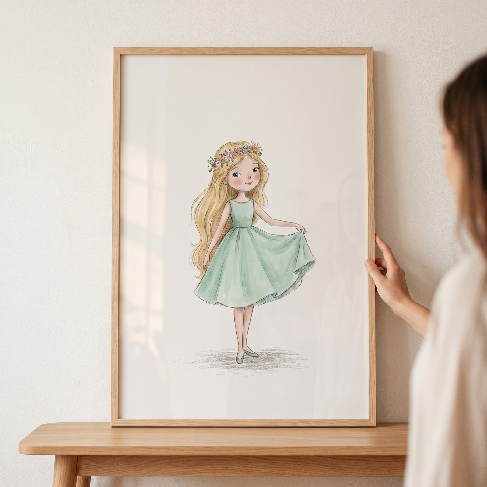 Framed mint green dress girl wall art of a blonde girl with a flower crown held by hands over a wooden table.