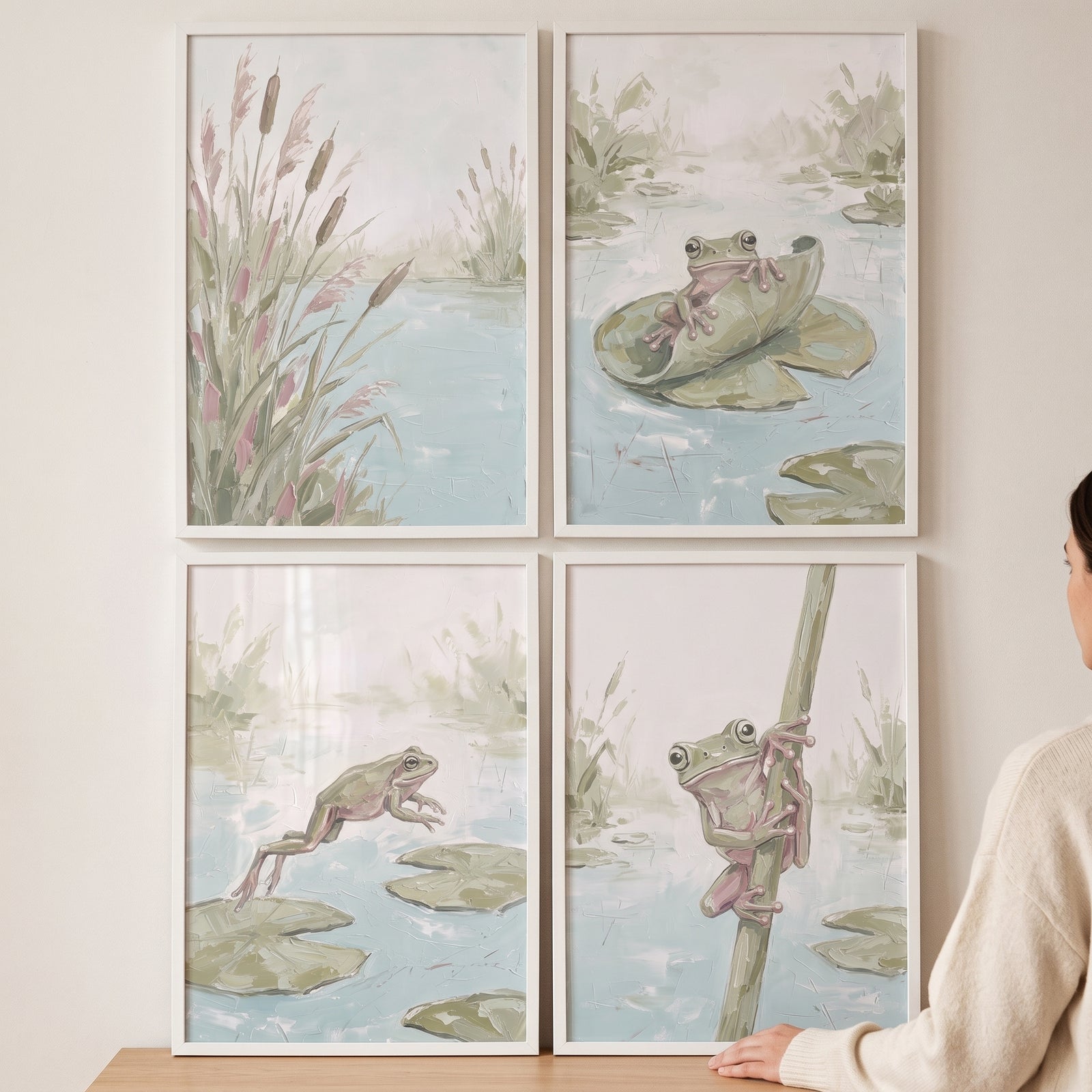 A misty sage wetland frog wall art set of 4 features frogs among reeds and lily pads in soft green, pink, and blue tones.