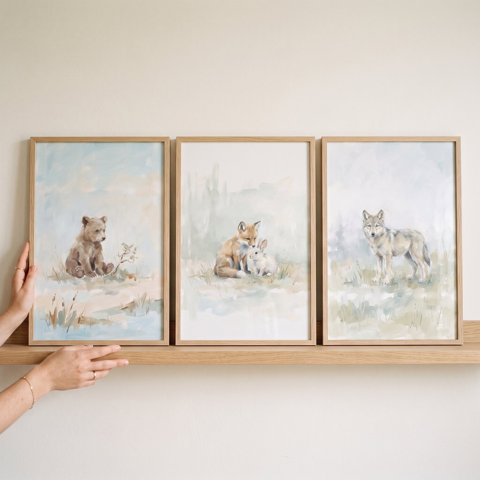 Misty sage woodland animals wall art set of 3 featuring a bear, fox, bunny, and wolf displayed on a wooden shelf.