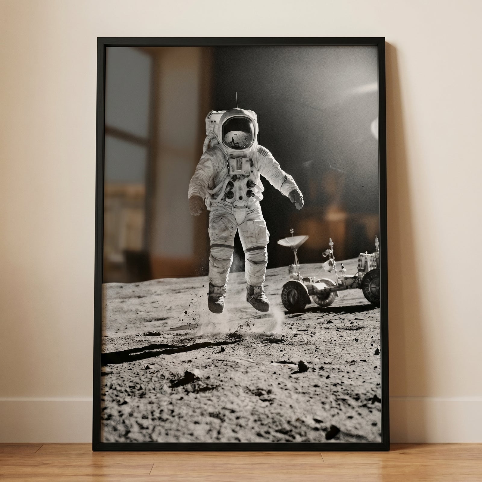 Monochrome moon jumping astronaut wall art shows a space explorer leaping above the cratered surface next to a rover.