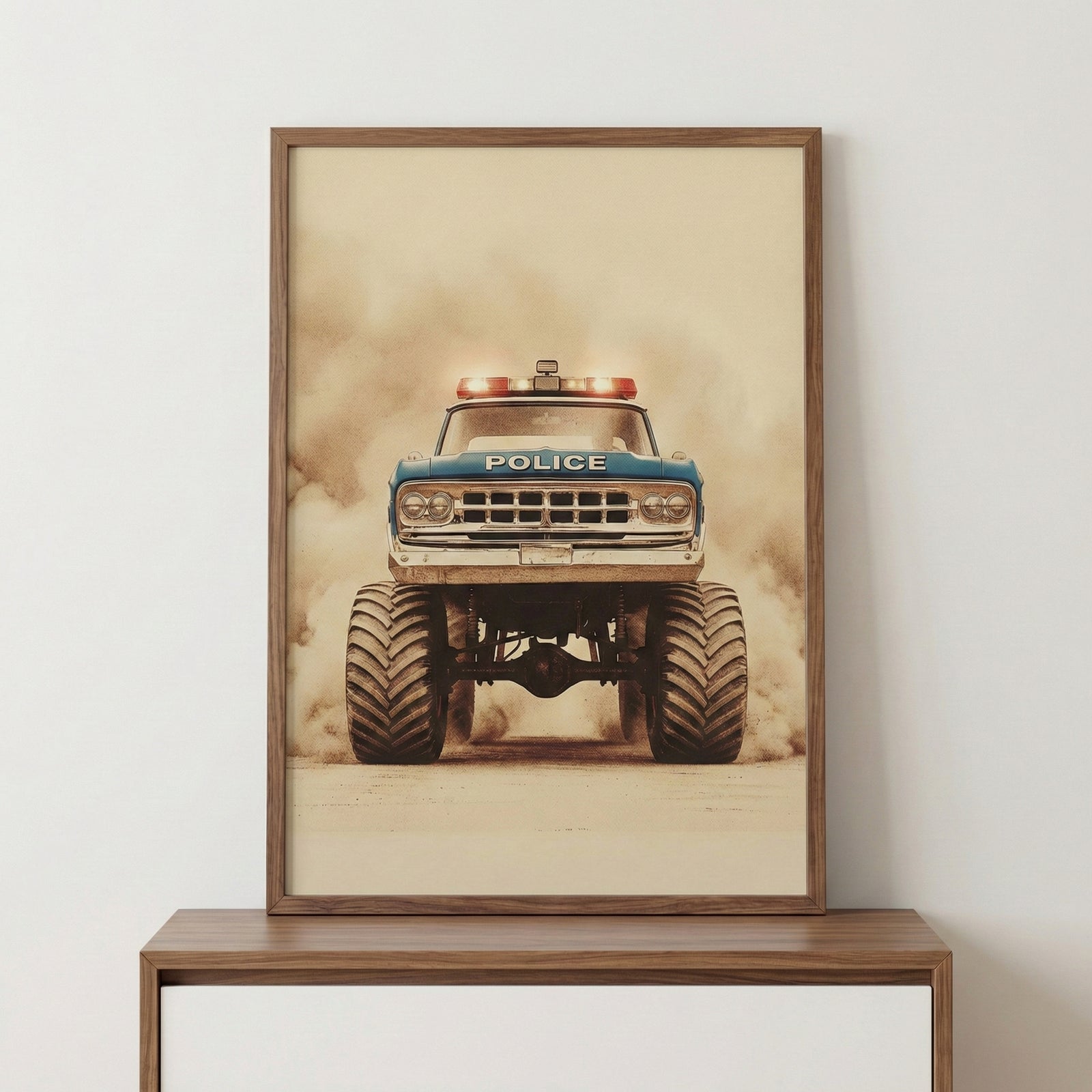 A vertical wood-framed print of a vintage blue monster truck styled as an emergency vehicle. The truck features massive, deeply treaded tires, a high-clearance suspension, and flashing light bars on the roof. The word "POLICE" is printed across the front hood. The image is captured from a low-angle front perspective as the vehicle drives through a thick cloud of dust, creating a dramatic and powerful scene. The artwork has a muted, sepia-toned aesthetic, giving it an aged look. The frame is placed on a smoo