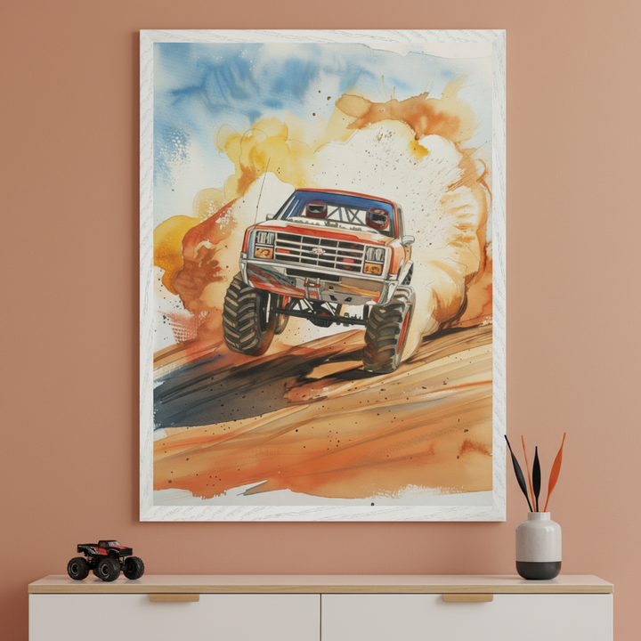 Modern space with a warm brown wall and a white dresser. A large framed watercolor painting of a red monster truck off-roading, kicking up dust, is centered above the dresser. A toy monster truck and a decorative vase are on the dresser.