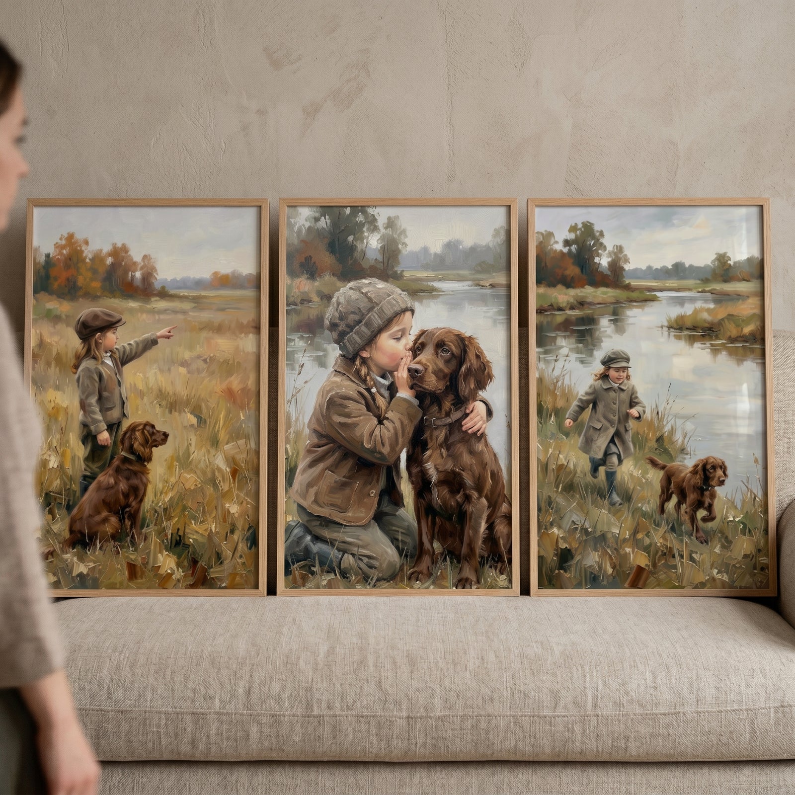 Moody autumn girl dog wall art set of 3 on a beige sofa, featuring a child and brown dog in rustic nature scenes.