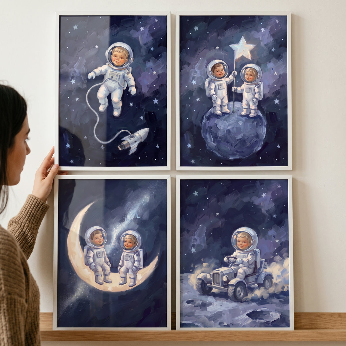 Moody indigo baby astronaut wall art set of 4 showing infants in space suits on a moon, a rover, and floating in space.