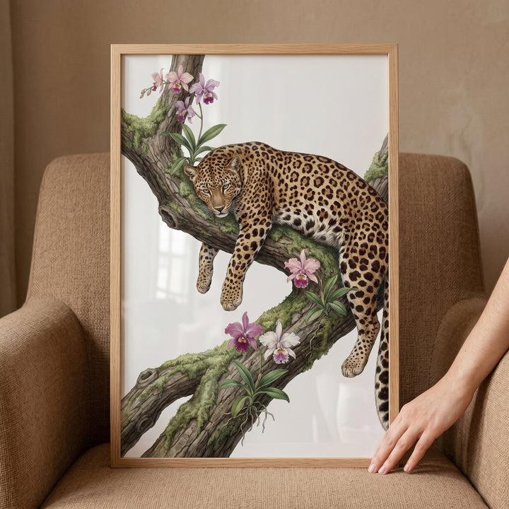 Framed mossy branch orchid leopard wall art displays a leopard resting on a tree limb among pink orchids and green moss.