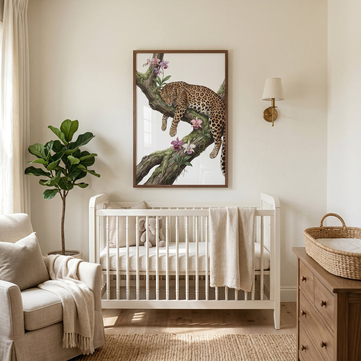 Neutral nursery with a white crib, beige armchair, potted plant, and mossy branch orchid leopard wall art.