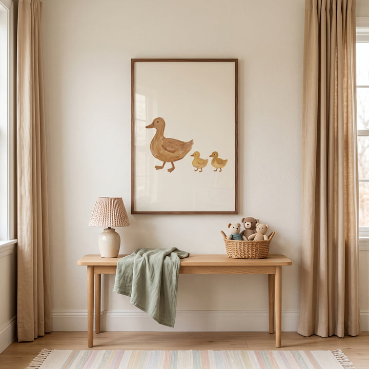 Mother and baby duck wall art above a wooden bench with a lamp, a green throw, and a basket of stuffed bears.