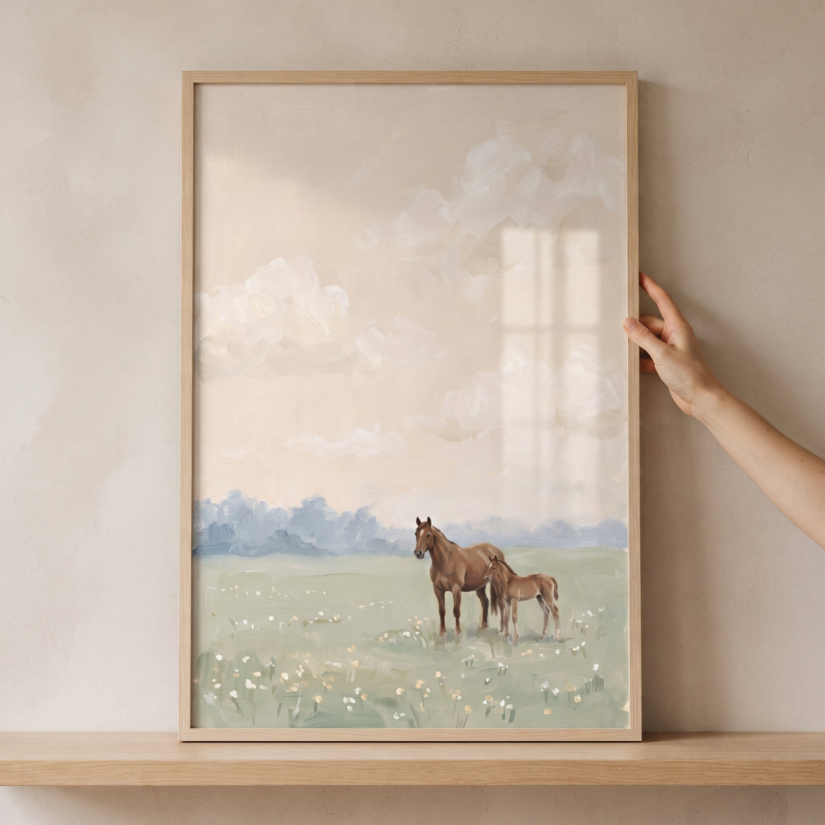 Framed mother baby brown horse wall art showing a mare and foal in a field of wildflowers under a muted, cloudy sky.