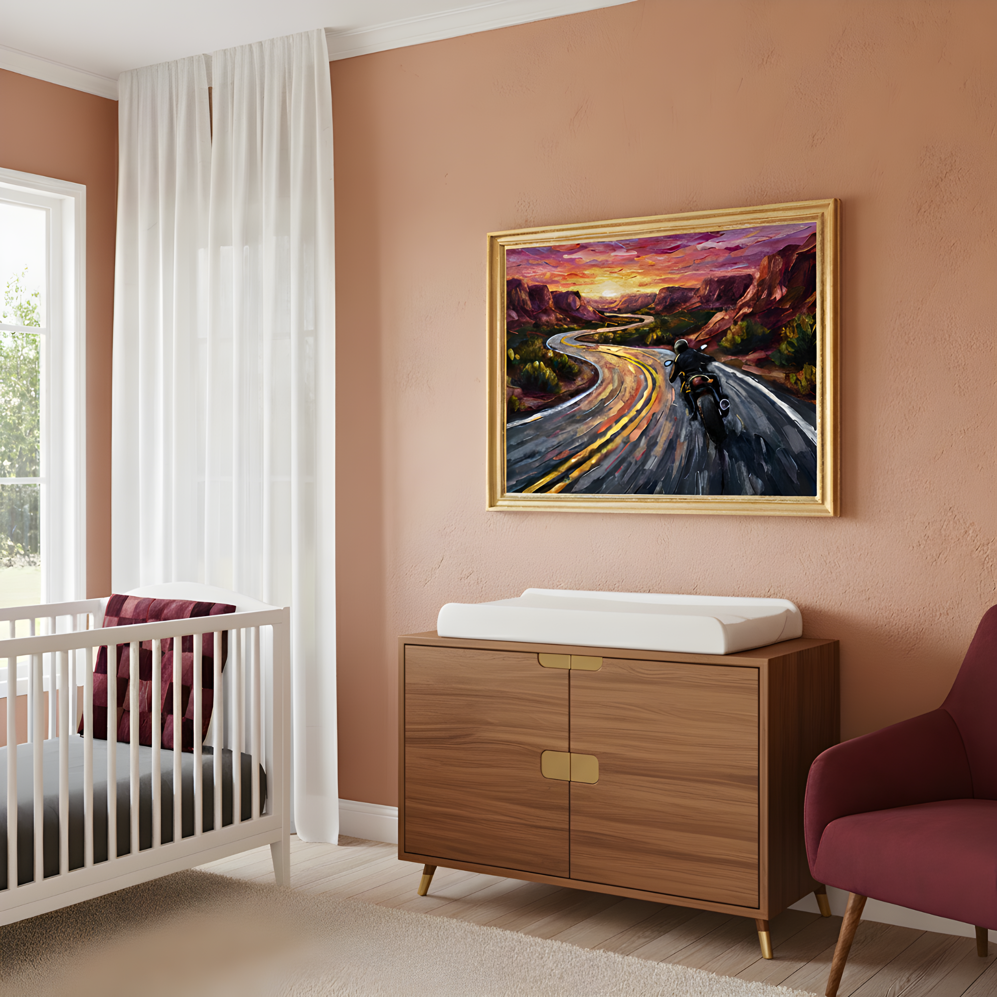 A nursery room with warm, peach-colored walls features a framed painting above a wooden changing table, showing a motorcyclist riding along a winding road at sunset. The space includes a white crib with a burgundy cushion and a deep red armchair, blending modern baby furniture with bold, adventurous artwork.