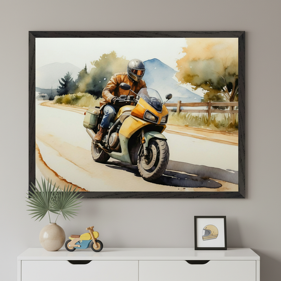 Modern living space with a white dresser. A large framed watercolor painting depicting a person on a yellow motorcycle on a winding road with a rural landscape hangs centered above the dresser. A vase, toy motorcycle, and helmet print are on the dresser.