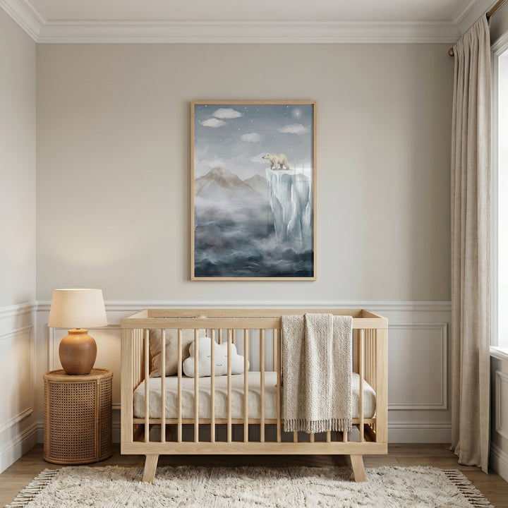 Mountain polar bear wall art hangs in a neutral nursery above a light wood crib with a cloud pillow and rattan table.
