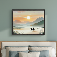 Modern bedroom with a muted green wall and a bed with a light wood headboard and neutral pillows. A large framed painting depicting a vibrant sunset over mountains with two silhouetted horseback riders hangs centered above the bed.