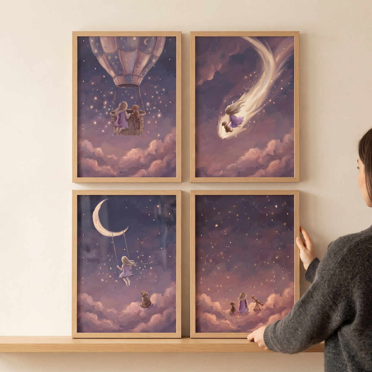 A person hangs a mulberry sky girl dog wall art set of 4 featuring dreamy scenes of a child and puppy among the stars.