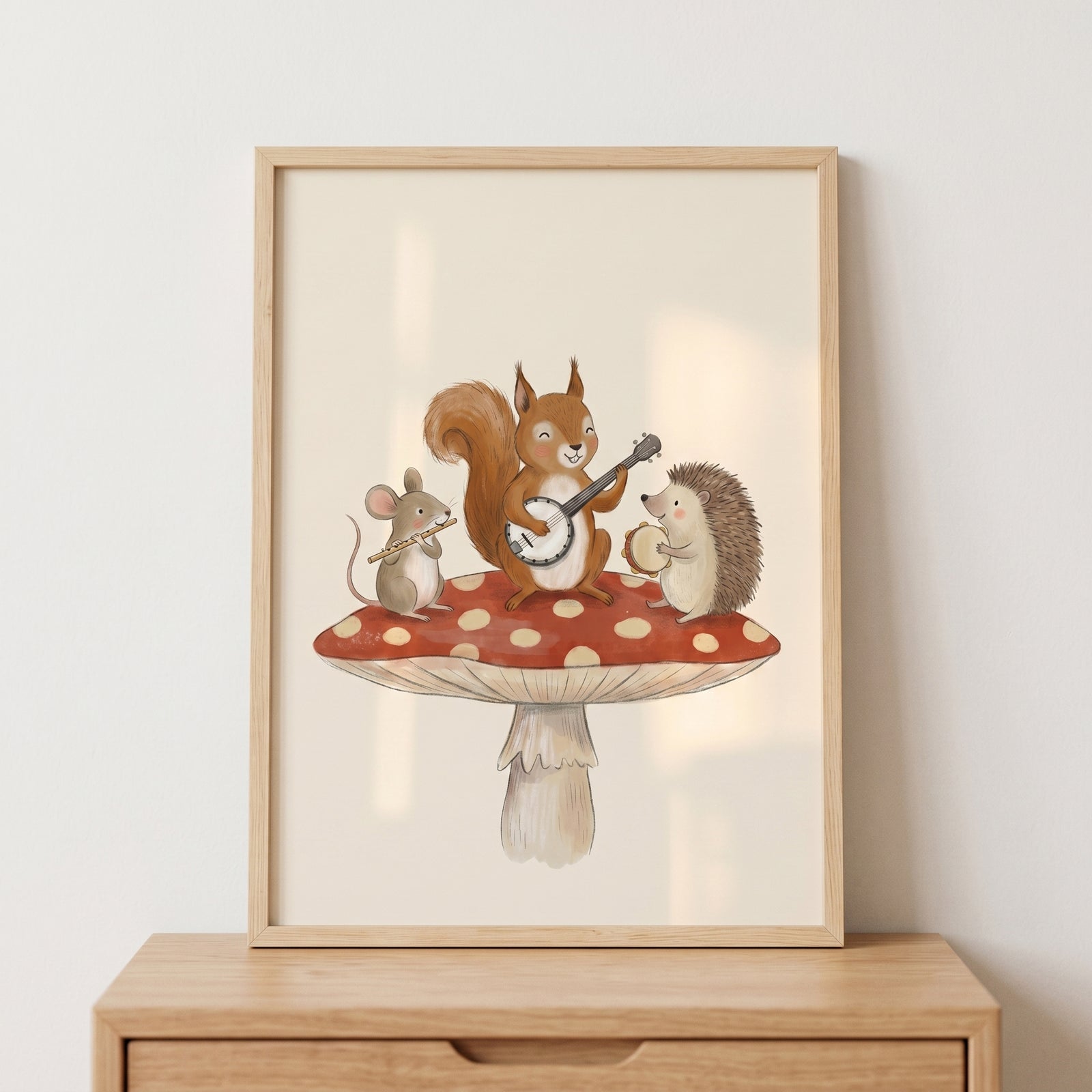 Musical woodland animals wall art with a mouse, squirrel, and hedgehog playing music on a red mushroom.