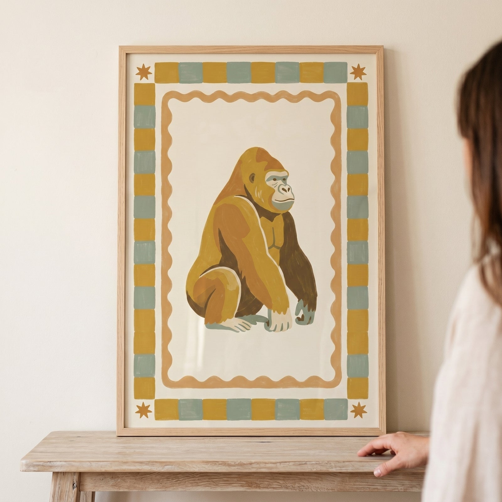 Mustard checkered border gorilla wall art features a golden gorilla sitting in a frame with stars and wavy patterns.
