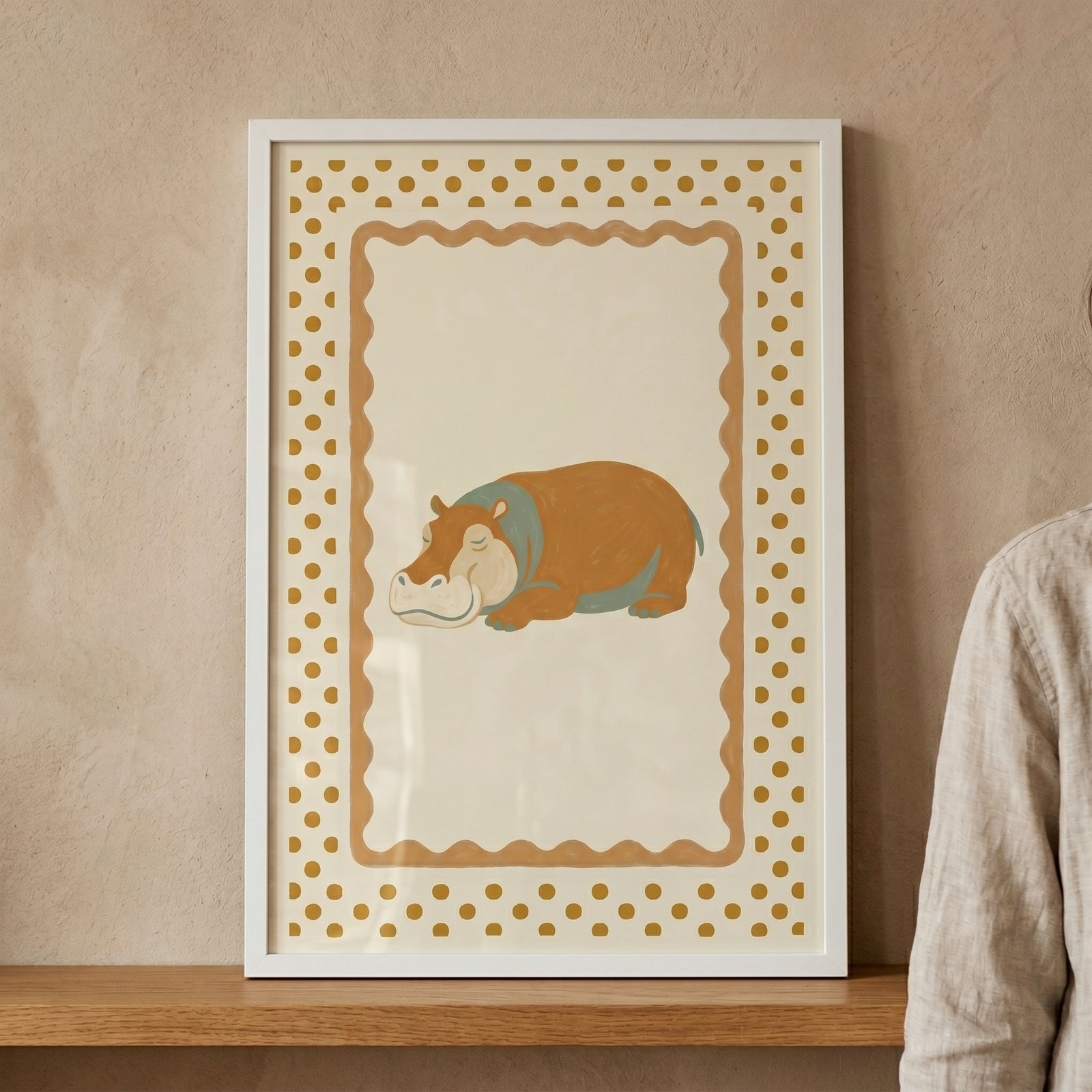 Framed mustard polka dot hippo wall art features a sleeping hippo on a cream background with a wavy border.