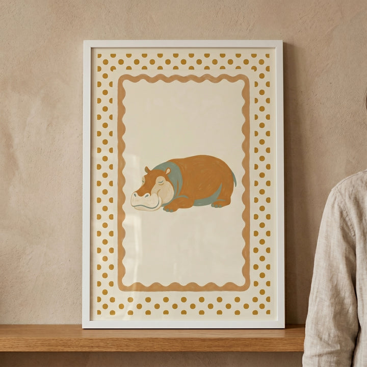 Framed mustard polka dot hippo wall art features a sleeping hippo on a cream background with a wavy border.