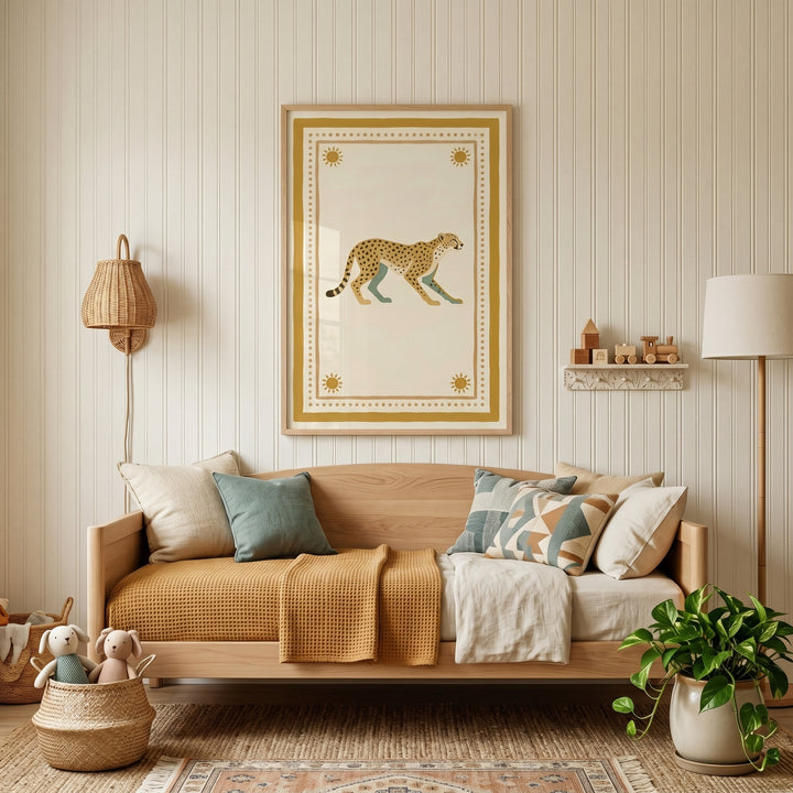 Mustard sun border cheetah wall art hangs above a wooden daybed with pillows, a potted plant, and a toy basket.