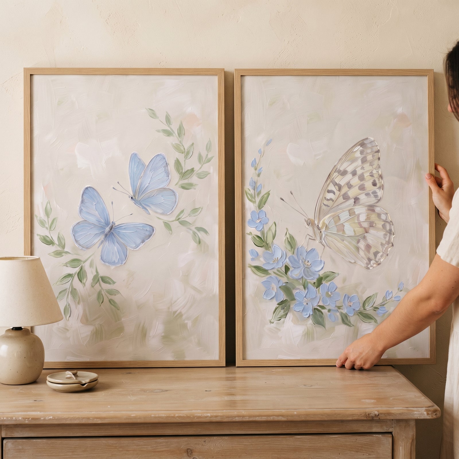 Muted blue garden butterfly artwork set of 2 in wood frames features soft blue butterflies and delicate flowers.