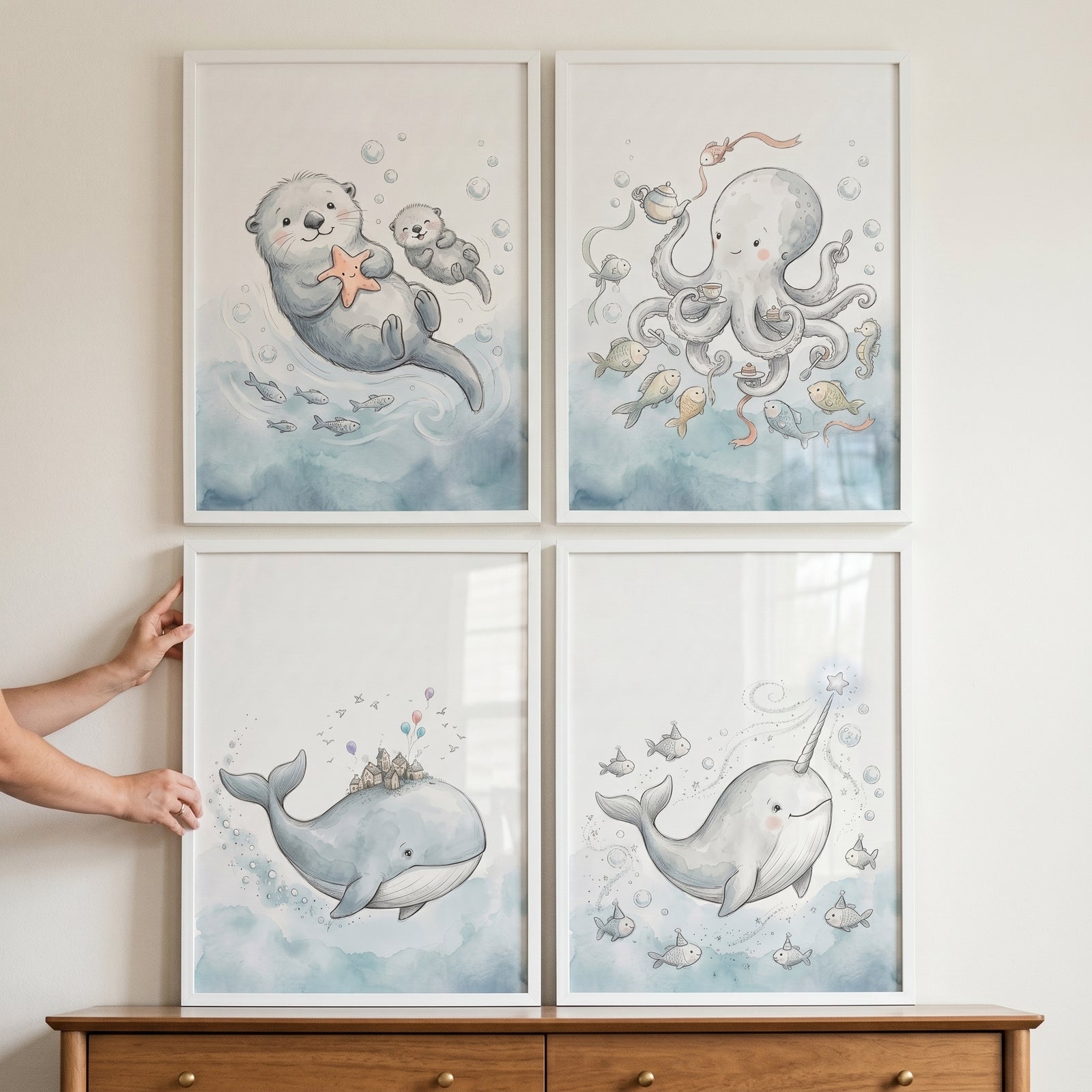 Muted blue ocean animal wall art set of 4 framed watercolor illustrations of an otter, octopus, whale, and narwhal.