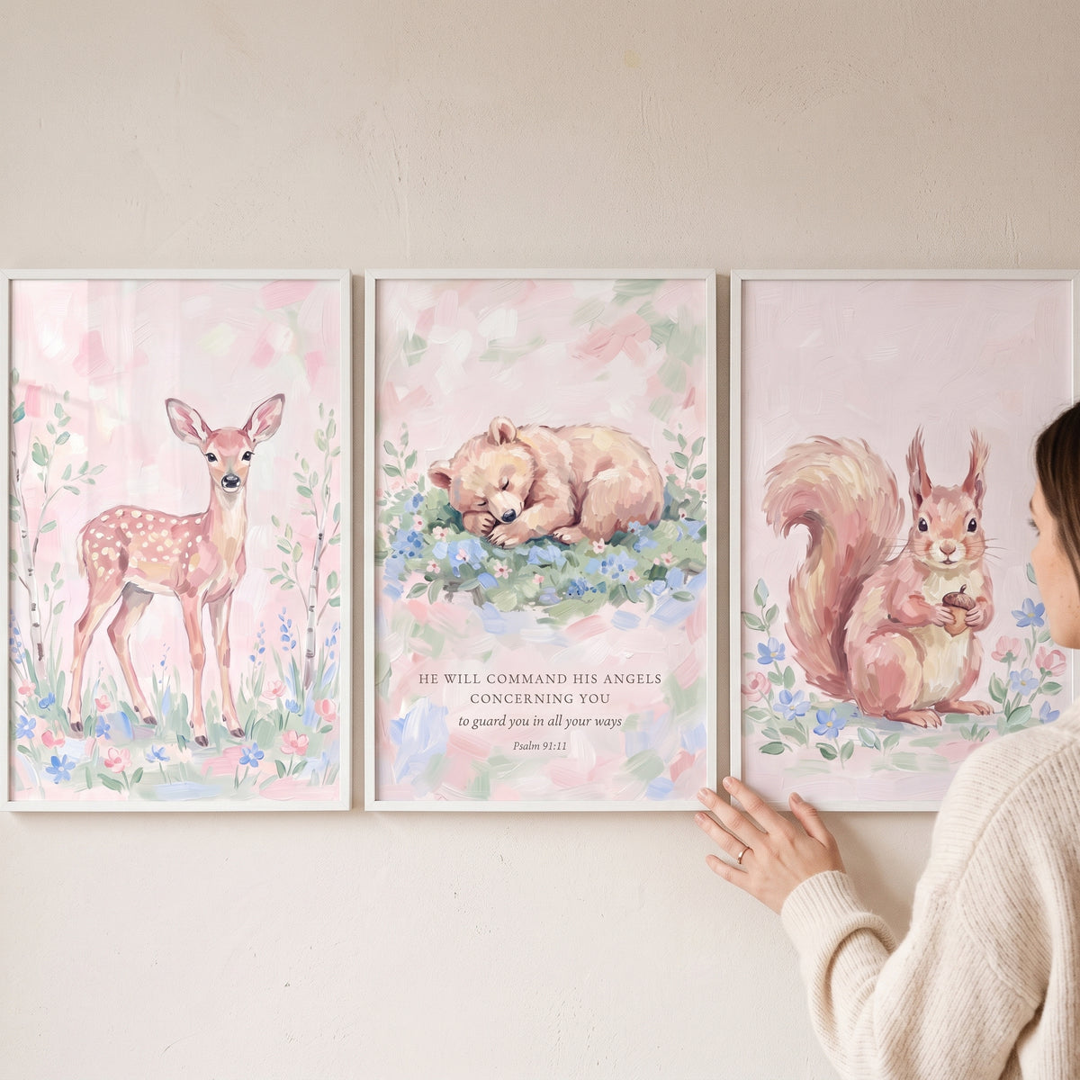 Muted botanical woodland animals wall art set of 3 featuring a fawn, bear cub with a Bible verse, and squirrel in pink tones.