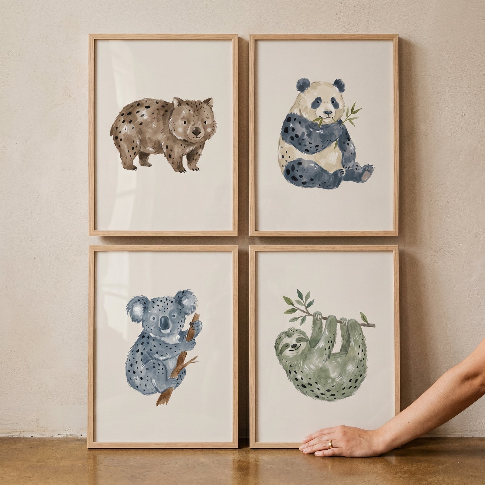 Muted earthy watercolor animals wall art set of 4 featuring a wombat, panda, koala, and sloth in wooden frames.