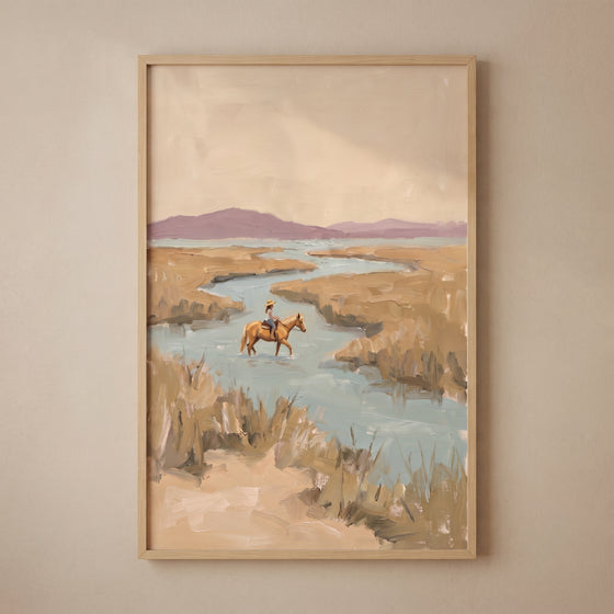 Muted landscape horse rider wall art depicts a figure crossing a river in a marsh under soft purple hills.