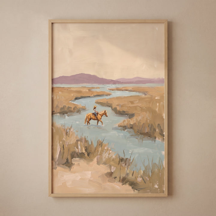 Muted landscape horse rider wall art depicts a figure crossing a river in a marsh under soft purple hills.