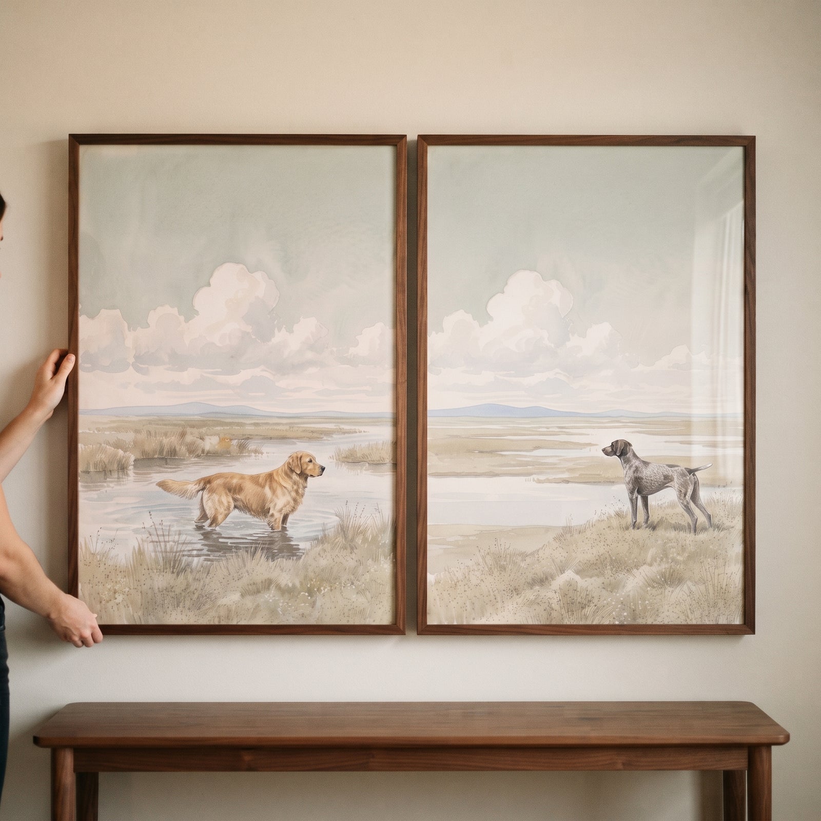 Muted marsh dog wall art set of 2 featuring a golden retriever and a pointer in framed landscape scenes above a bench.