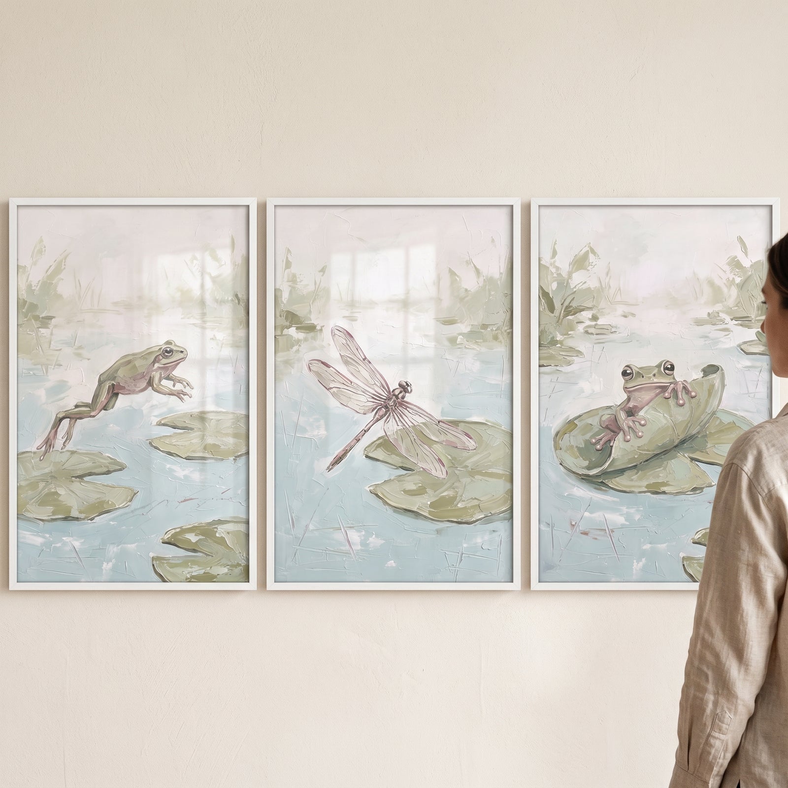 Muted mossy aquatic animals wall art set of 3 with framed frogs and a dragonfly among lily pads in soft green and blue.