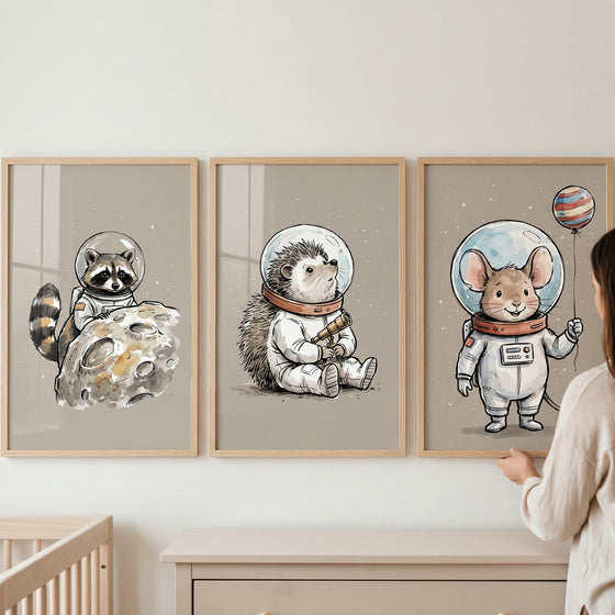 Muted neutral astronaut animal wall art set of 3 featuring a raccoon, hedgehog, and mouse in space suits.