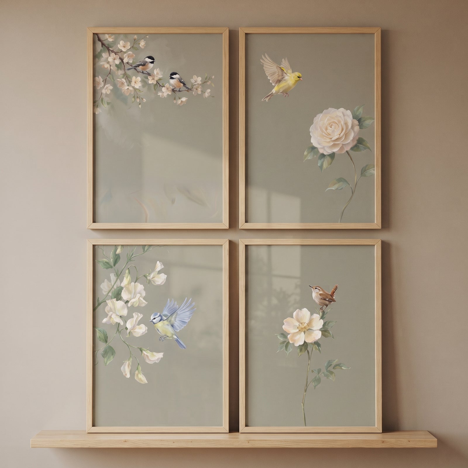 Muted neutral floral bird wall art set of 4 featuring small birds and white blossoms in light wood frames on a shelf.