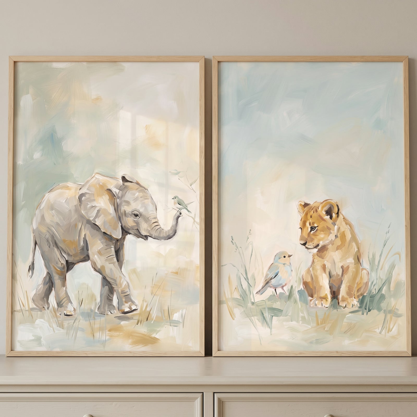 Baby elephant and lion cub with birds in a muted pastel safari animals wall art set of 2.