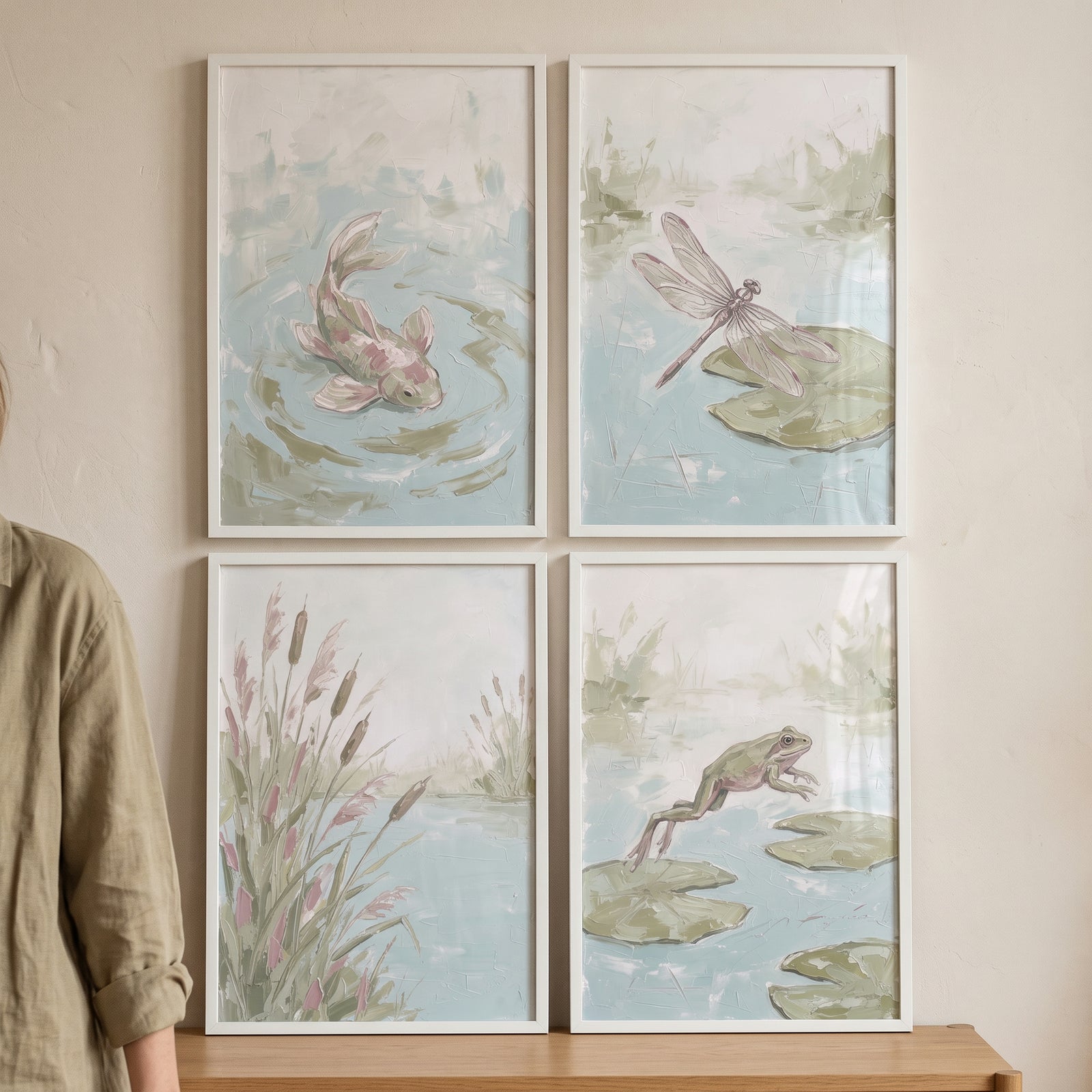 Muted sage aquatic pond wall art set of 4 featuring a fish, dragonfly, reeds, and frog in white frames.