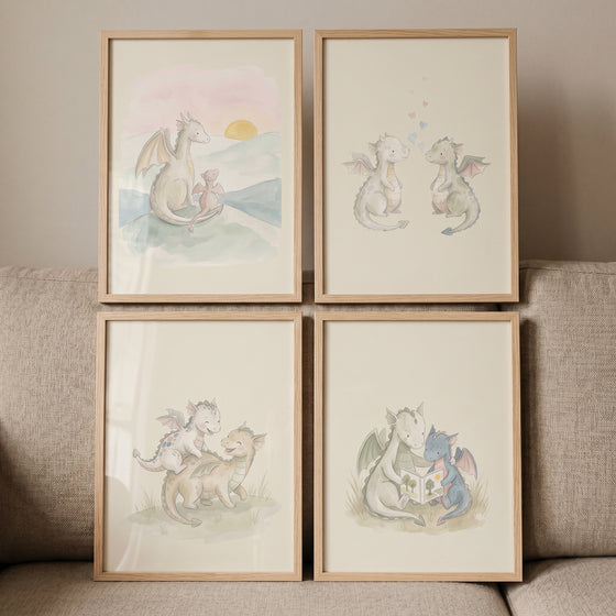 Muted sage baby dragon wall art set of 4 featuring watercolor illustrations of dragons in light wood frames.