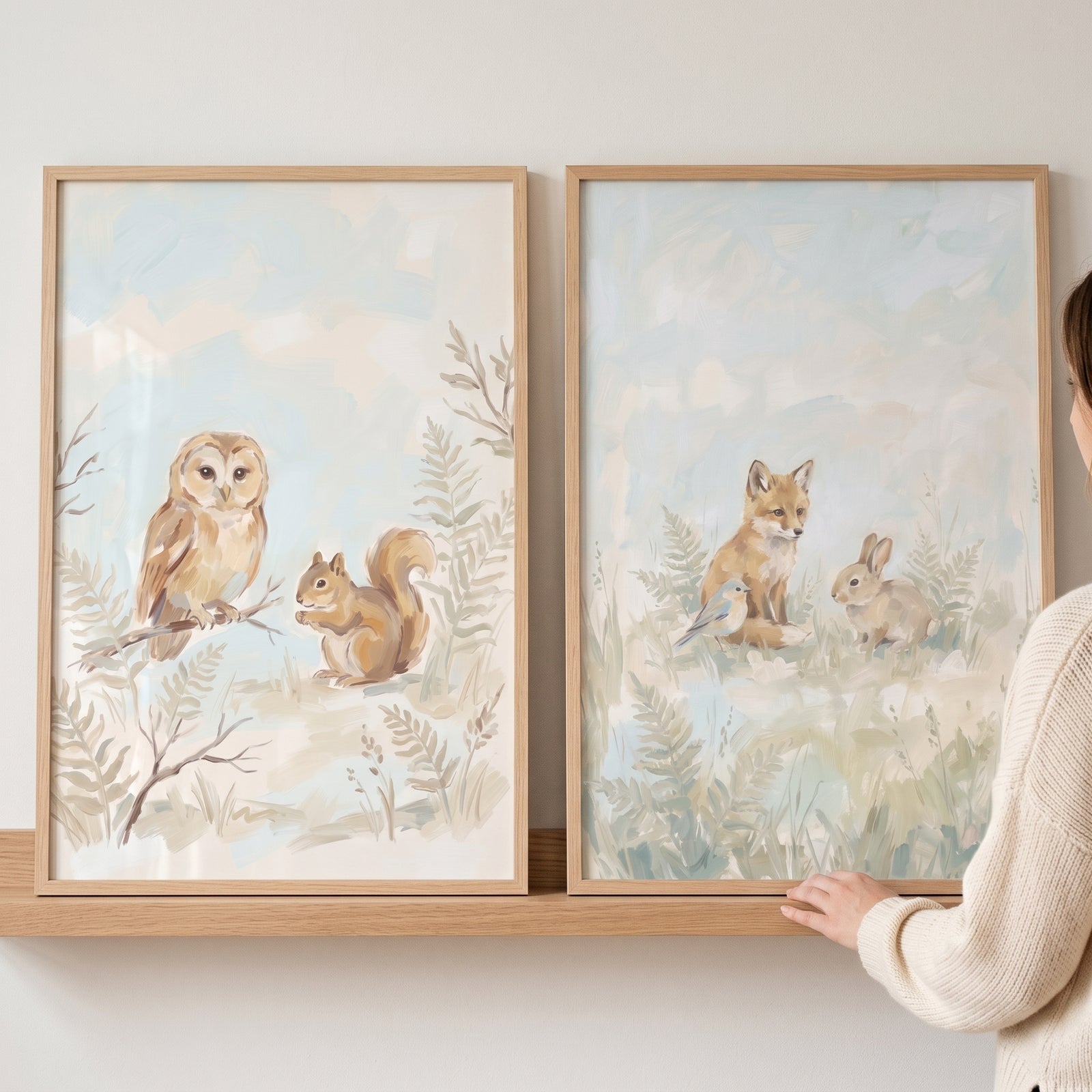 Framed muted sage forest animals wall art set of 2 featuring an owl, squirrel, fox, and rabbit displayed on a shelf.