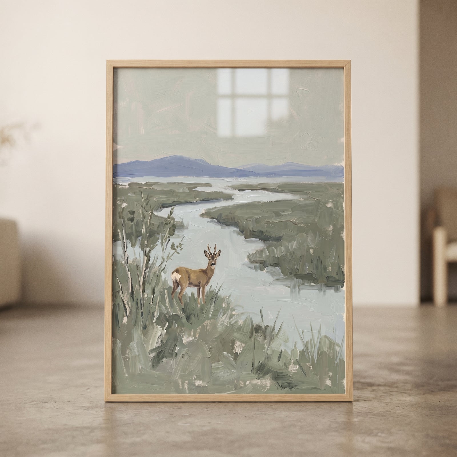 Muted sage marsh buck wall art with a buck standing in brush near a winding river and distant blue mountains.