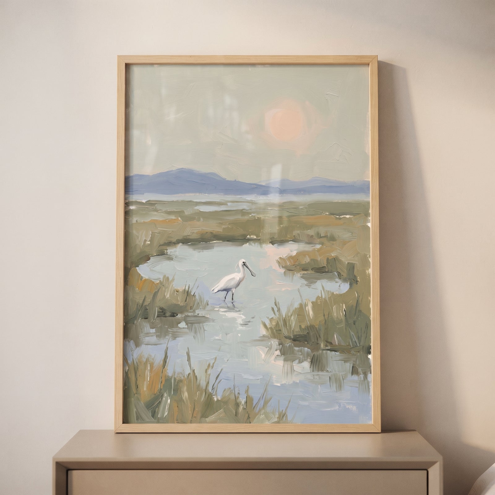 Muted sage marsh spoonbill bird wall art features a white bird in a wetland landscape with mountains and a pale sun.