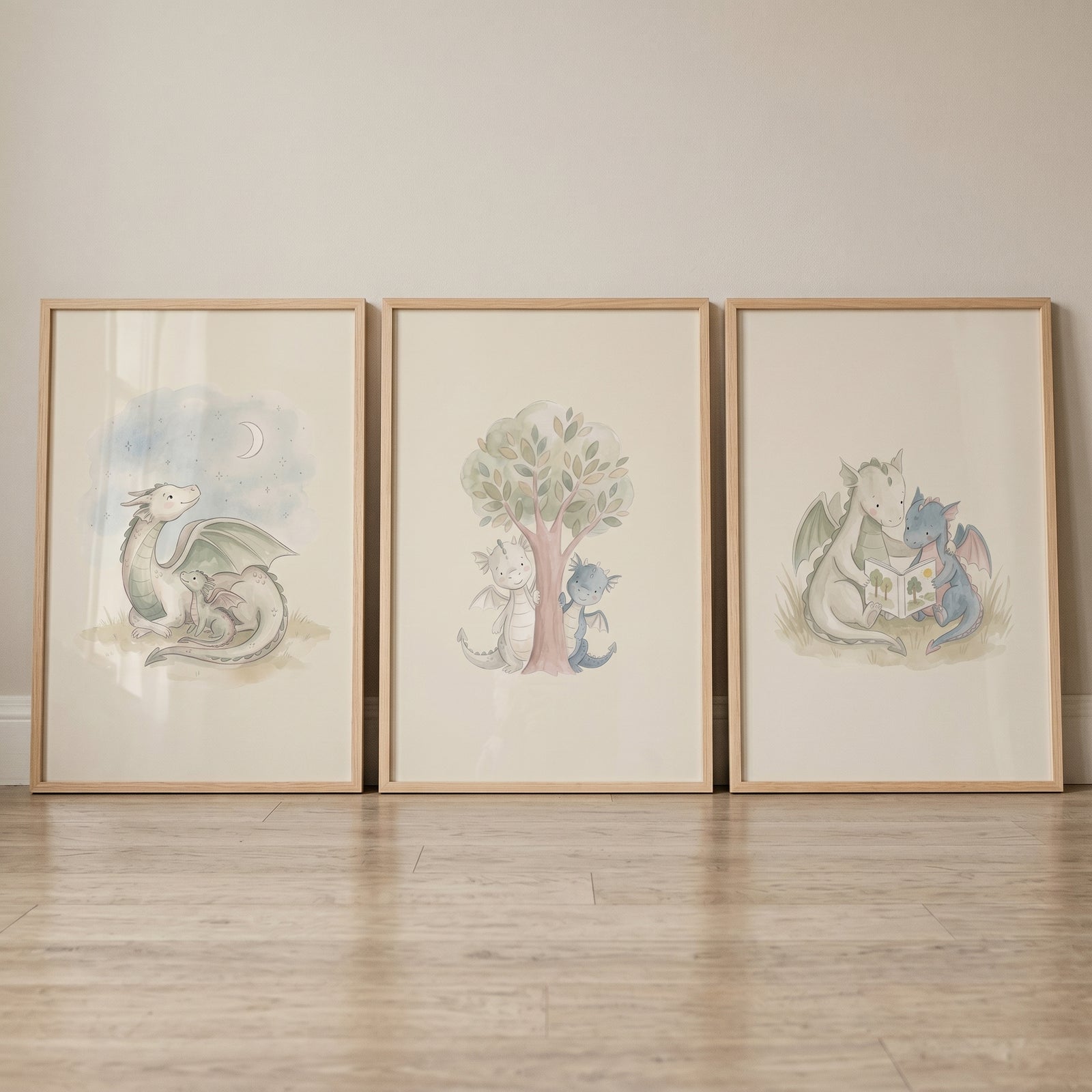 Muted sage mythical dragons wall art set of 3 in wood frames features dragons reading, by a tree, and with a moon.