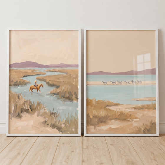 Muted sand landscape horses wall art set of 2 featuring a rider in a marshy stream and a herd standing in blue water.