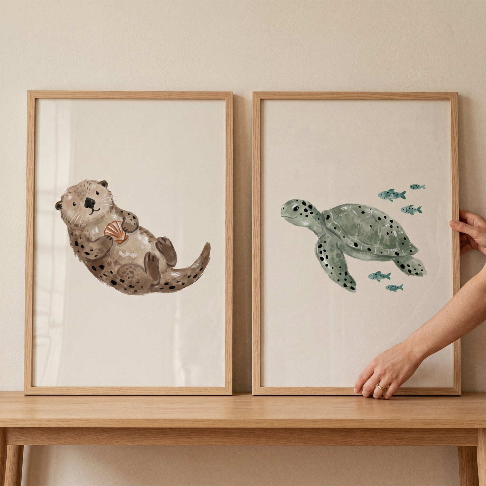 Muted spotted sea creature print set of 2 featuring a brown otter with a shell and a green sea turtle.