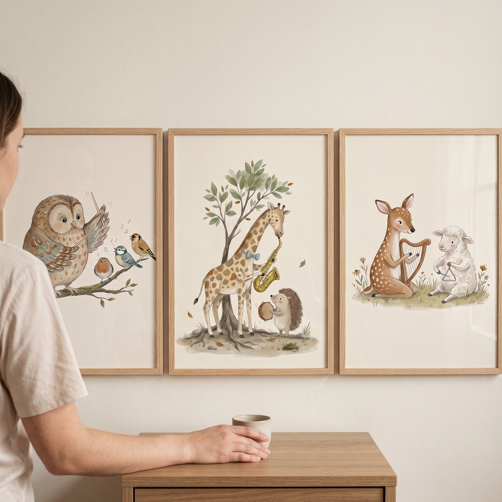 Muted taupe musical animal wall art set of 3 depicts animals playing instruments above a person holding a mug.