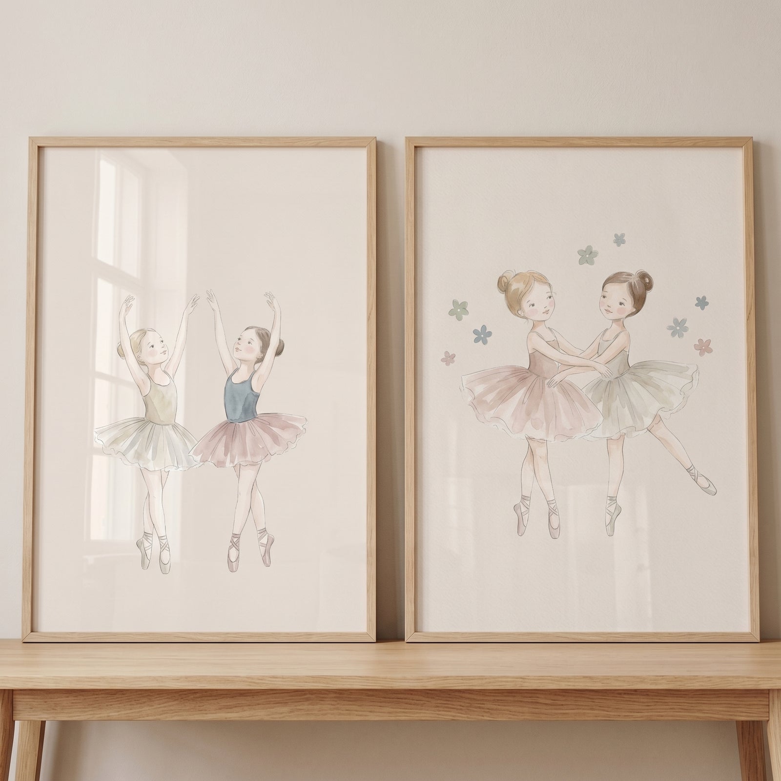 Muted tone dancing ballerina wall art set of 2 in light wood frames, showing young girls in tutus on a wooden table.