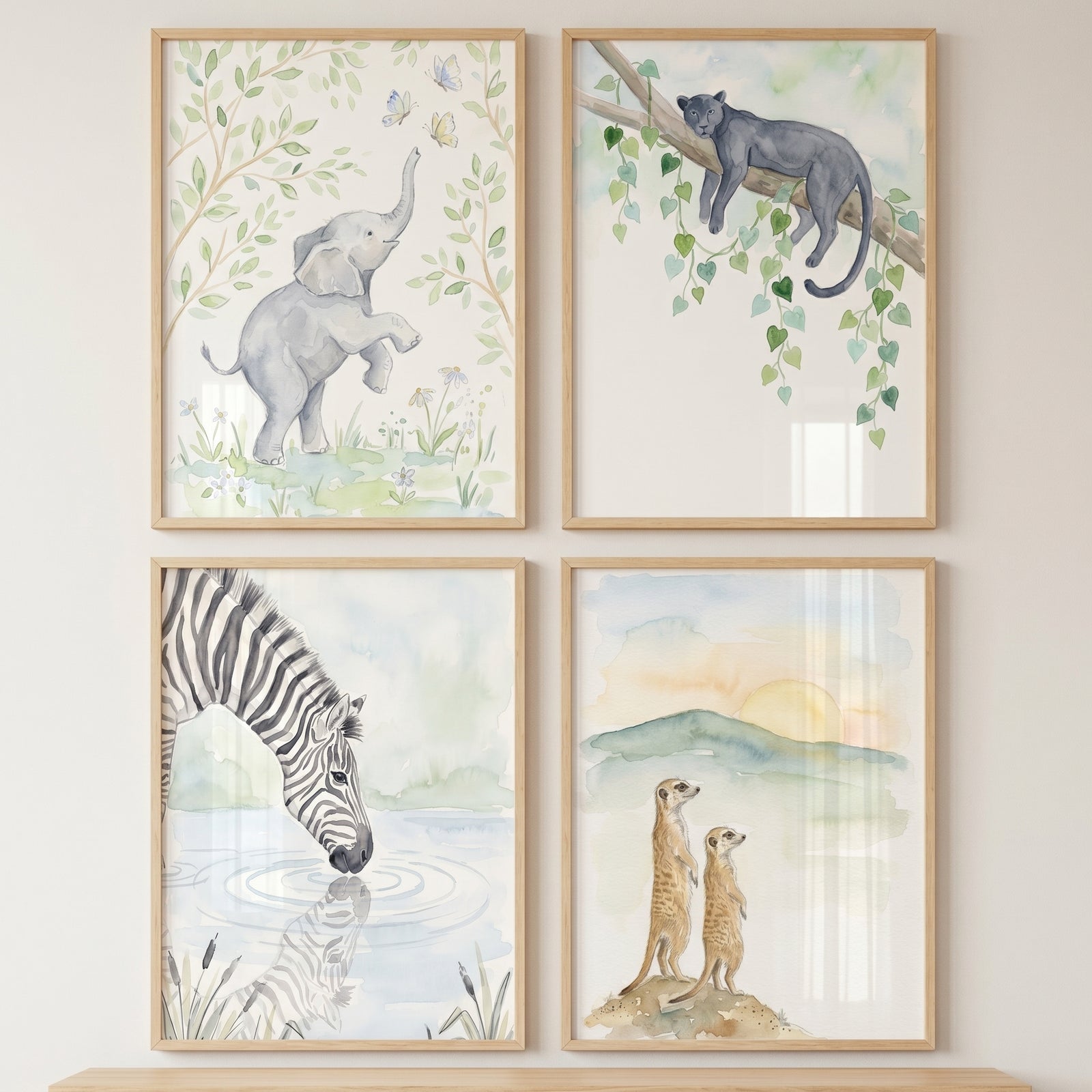 Muted tone safari animal artwork set of 4 featuring an elephant, panther, drinking zebra, and meerkats in light frames.